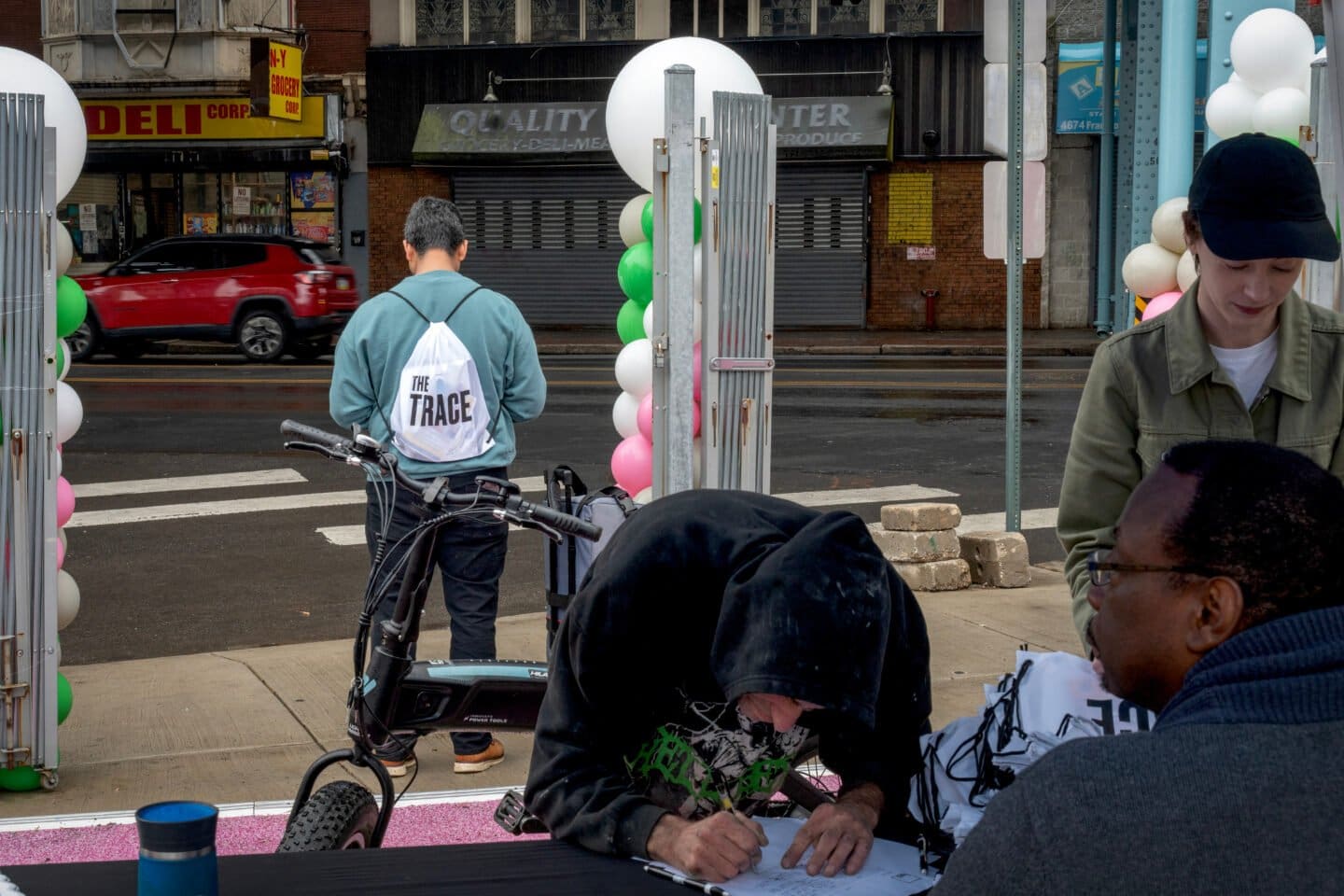 A photo of a 2024 event hosted by The Trace in Philadelphia. Trace staffers in the foreground and a person wearing a Trace backpack in the background.